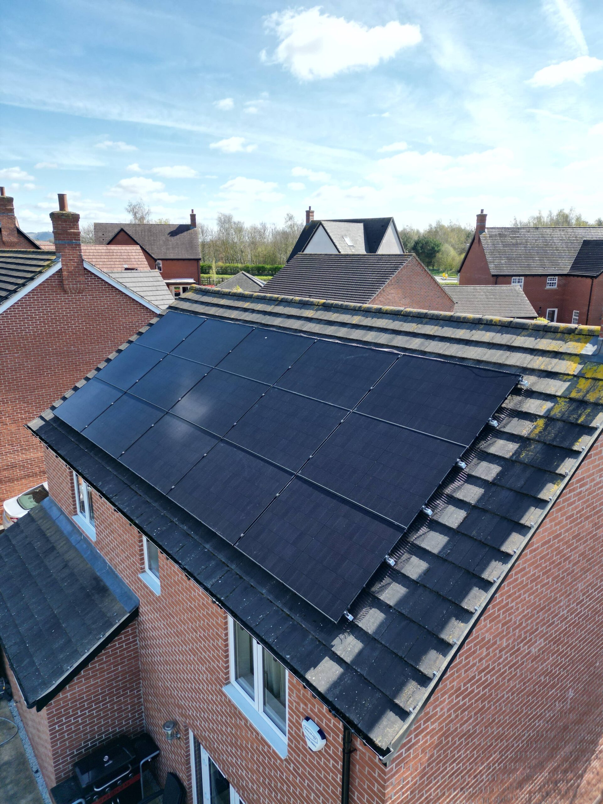 aerial view of solar panels on the roof of a house